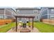 Landscaped backyard featuring a pergola, fire pit, and seating area, perfect for outdoor entertaining at 715 N Amory St, Watkins, CO 80137