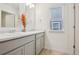Well-lit bathroom featuring double sinks, neutral countertops, and modern fixtures at 715 N Amory St, Watkins, CO 80137