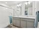 Bathroom features dual sinks, a shower with glass door and a towel rack at 715 N Amory St, Watkins, CO 80137