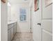 Stylish bathroom boasting a window, double sinks, and modern gray cabinets at 715 N Amory St, Watkins, CO 80137