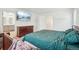 Bright bedroom features a dresser, TV, and ensuite bathroom for added convenience at 715 N Amory St, Watkins, CO 80137