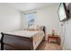 This carpeted bedroom features a window and TV mounted on the wall at 715 N Amory St, Watkins, CO 80137