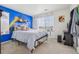 Fun bedroom with a colorful accent wall, comfortable bed, and bright decor at 715 N Amory St, Watkins, CO 80137