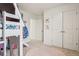 Bright bedroom with a unique loft bed design, plush carpet, and ample closet space at 715 N Amory St, Watkins, CO 80137