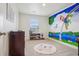 Whimsical room with a colorful mural and neutral carpet for a cozy and creative space at 715 N Amory St, Watkins, CO 80137