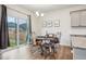 A bright dining area with sliding glass doors leading to the backyard and view of the fence at 715 N Amory St, Watkins, CO 80137