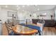 Open-concept dining area features a table with seating flowing into the living room and kitchen at 715 N Amory St, Watkins, CO 80137