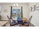 Cozy dining area with decorative lighting, a round table, and access to the backyard at 715 N Amory St, Watkins, CO 80137