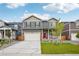 Charming two-story home features a covered porch, well-maintained lawn, and an attached two-car garage at 715 N Amory St, Watkins, CO 80137