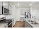 Modern kitchen design with gray cabinets, stainless steel appliances, and granite countertops at 715 N Amory St, Watkins, CO 80137