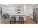 Eat-in kitchen boasts stainless appliances, granite countertops, and a central island with barstool seating at 715 N Amory St, Watkins, CO 80137