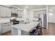Well-equipped kitchen features a stainless steel oven, microwave, and granite countertop island with seating at 715 N Amory St, Watkins, CO 80137
