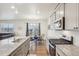 The kitchen features stainless steel appliances, granite countertops, and a view of the dining area at 715 N Amory St, Watkins, CO 80137