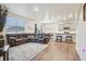 Spacious living room with wood floors, recessed lighting, open floor plan, and modern furniture at 715 N Amory St, Watkins, CO 80137