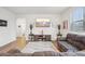 Bright living room featuring a cozy rug, a wall-mounted TV, and a comfortable seating area at 715 N Amory St, Watkins, CO 80137