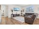 Comfortable living room with a plush rug, contemporary decor, and plenty of natural light at 715 N Amory St, Watkins, CO 80137