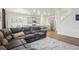Comfortable living space with wood floors and a view of the modern kitchen and dining area at 715 N Amory St, Watkins, CO 80137
