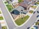 Aerial view of a two-story home with a gray exterior, stone accents, manicured lawn, and a two-car garage at 880 Mcmurdo Cir, Castle Rock, CO 80108