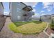 Landscaped backyard featuring a grassy area, rock border and a deck with stairs at 880 Mcmurdo Cir, Castle Rock, CO 80108
