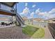Backyard with grassy area, landscaped rocks and under-deck patio with furniture at 880 Mcmurdo Cir, Castle Rock, CO 80108