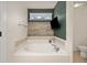 Bathroom with a soaking tub and television at 880 Mcmurdo Cir, Castle Rock, CO 80108