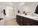 Bathroom featuring double sink vanity, tub with shower and tile flooring at 880 Mcmurdo Cir, Castle Rock, CO 80108
