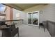 Covered deck featuring wicker chairs with view of the neighborhood at 880 Mcmurdo Cir, Castle Rock, CO 80108