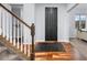 Bright entryway with hardwood floors, a staircase, and a black front door creating a modern feel at 880 Mcmurdo Cir, Castle Rock, CO 80108