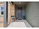 Inviting front porch with stone pillars, chair, and neutral siding, creating a welcoming entrance at 880 Mcmurdo Cir, Castle Rock, CO 80108