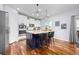 Kitchen island with stone counters, stylish pendant lighting, and bar stool seating at 880 Mcmurdo Cir, Castle Rock, CO 80108