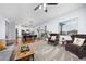 Open-concept living room flows into the dining area with hardwood floors and lots of light at 880 Mcmurdo Cir, Castle Rock, CO 80108