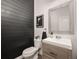 Stylish powder room features a wood accent wall and a modern sink vanity at 880 Mcmurdo Cir, Castle Rock, CO 80108