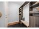 Organized walk-in closet features custom shelving, a bench, and hardwood floors at 880 Mcmurdo Cir, Castle Rock, CO 80108