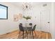 Chic dining room featuring modern chandelier and a glass table set for four at 1719 Grove St, Denver, CO 80204