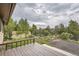 A wood deck with a beautiful view overlooking the yard, with a shed and trees at 30839 Manitoba Dr, Evergreen, CO 80439