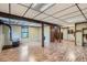 Basement view featuring light wood-look floors, wood support columns, built-in shelving, and a wood-burning stove at 30839 Manitoba Dr, Evergreen, CO 80439
