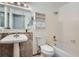 Bright bathroom with classic white fixtures, a vanity, and a tub-shower combo at 30839 Manitoba Dr, Evergreen, CO 80439
