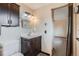 Bathroom featuring sink with storage, mirror and modern vanity lights at 30839 Manitoba Dr, Evergreen, CO 80439