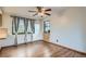 Inviting bedroom with hardwood floors, a ceiling fan, and view-framing windows at 30839 Manitoba Dr, Evergreen, CO 80439