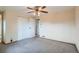 Neutral-toned bedroom with carpet, a closet, and a doorway leading to another room at 30839 Manitoba Dr, Evergreen, CO 80439