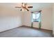 Cozy bedroom featuring soft carpet, a ceiling fan, and lovely window at 30839 Manitoba Dr, Evergreen, CO 80439