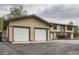 Spacious home exterior shows a two-car garage with attached home and long driveway at 30839 Manitoba Dr, Evergreen, CO 80439