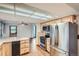 Functional kitchen with stainless steel appliances, wood cabinets, a tile counter and wood floors at 30839 Manitoba Dr, Evergreen, CO 80439
