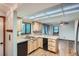 Eat-in kitchen featuring wood cabinets, black appliances, double sink, and a window view at 30839 Manitoba Dr, Evergreen, CO 80439