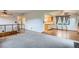 Open living and dining area with ceiling fans and wood floors adjacent to a cozy living room space at 30839 Manitoba Dr, Evergreen, CO 80439
