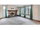 Inviting living room with a stone fireplace and scenic views through large windows at 30839 Manitoba Dr, Evergreen, CO 80439