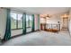Bright living room with large windows showing scenic views, carpet, and an open staircase at 30839 Manitoba Dr, Evergreen, CO 80439
