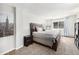 Cozy bedroom featuring carpeted floors, a large bed, a nightstand, and a view of natural light at 6930 E Girard Ave # 304, Denver, CO 80224