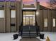 The Morningside Clubhouse entry features glass doors and snow-covered stairs in front of a beige brick facade at 6930 E Girard Ave # 304, Denver, CO 80224