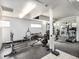 Community gym featuring weightlifting equipment, machines, and mirrored walls at 6930 E Girard Ave # 304, Denver, CO 80224